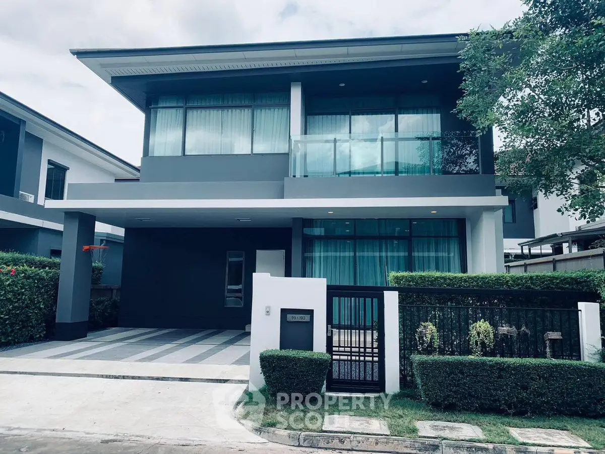 Modern two-story house with sleek design and spacious driveway in a serene neighborhood.