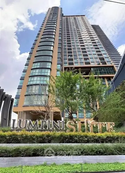 Modern high-rise building with lush greenery at Lumpini Suite.