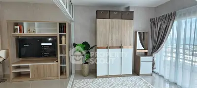 Modern living room with stylish furniture and large window offering scenic views.