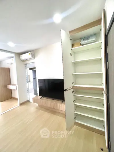 Modern living room with built-in storage and TV unit in stylish apartment