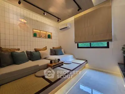 Modern living room with cozy seating, ambient lighting, and stylish decor.
