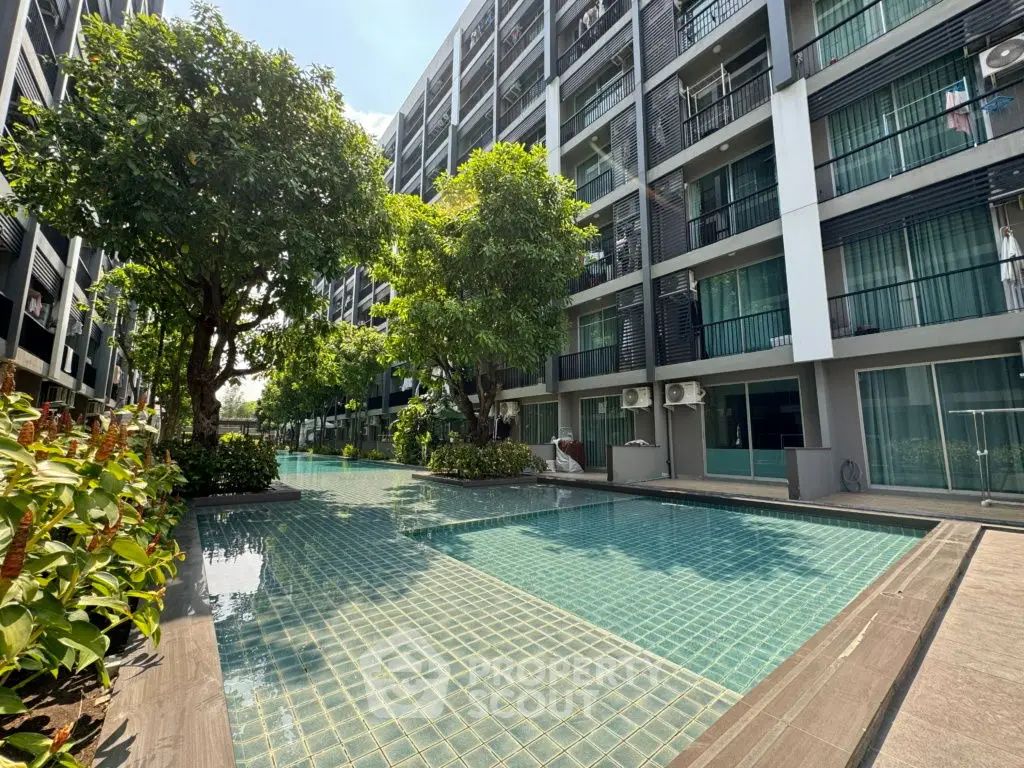 Modern condominium with pool and lush greenery, perfect for urban living.