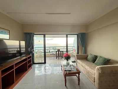 Spacious living room with ocean view and balcony access, perfect for relaxation and entertaining.