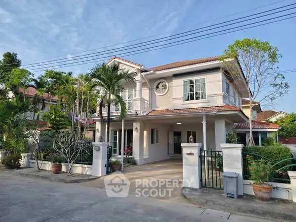 Charming two-story house with lush garden and spacious driveway in a serene neighborhood.