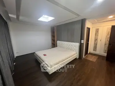 Spacious bedroom with elegant design and ample natural light