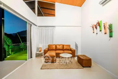 Modern living room with leather sofa and balcony view