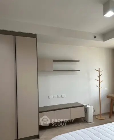 Modern bedroom with minimalist furniture and neutral tones