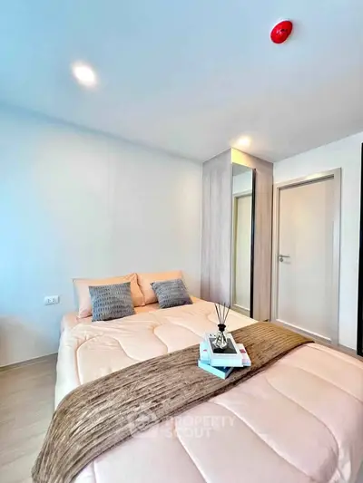Modern bedroom with cozy bedding and sleek wardrobe design