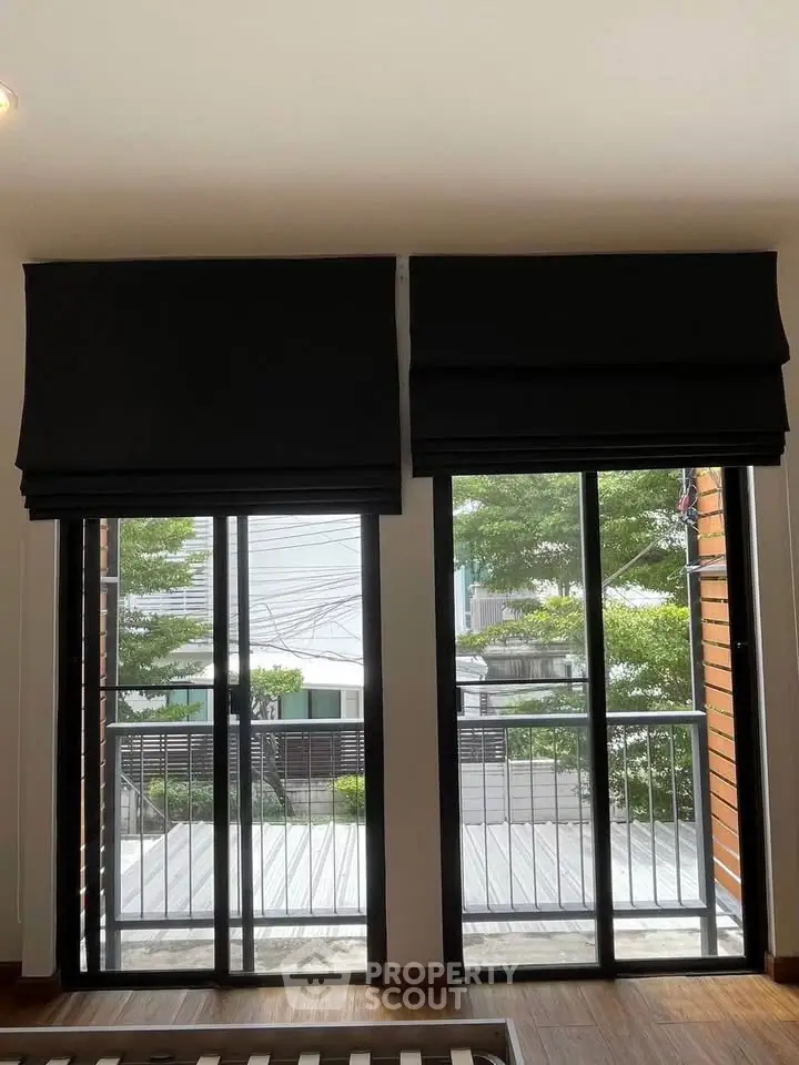 Modern apartment with floor-to-ceiling windows and balcony view