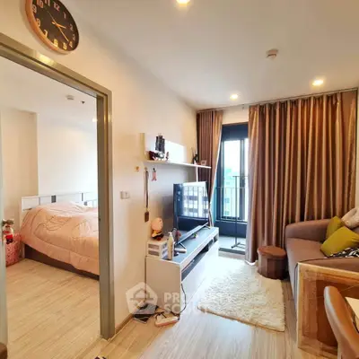Modern living room with cozy decor and balcony access in a stylish apartment.