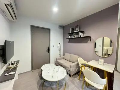 Modern living room with stylish decor, featuring a cozy sofa, marble coffee table, and wall-mounted TV.