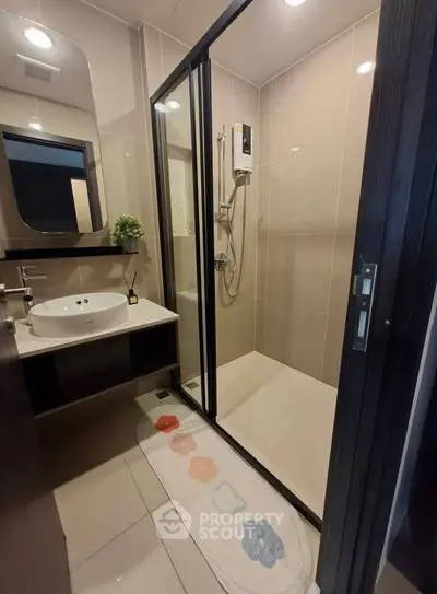 Modern bathroom with glass shower enclosure and sleek vanity