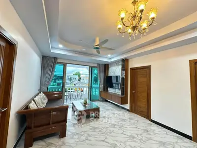 Elegant living room with chandelier and balcony view