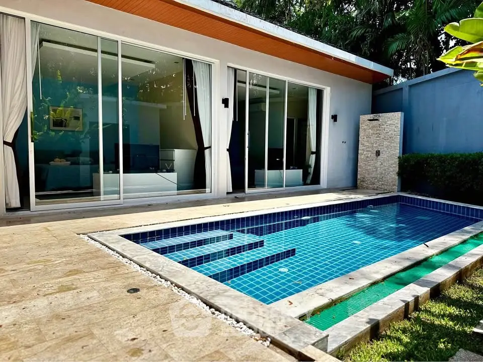 Luxurious villa with private pool and modern glass sliding doors, perfect for relaxation and entertainment.