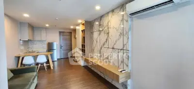 Modern living room with marble accent wall and open kitchen layout