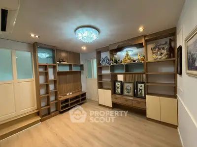 Spacious living room with elegant built-in shelves and modern lighting