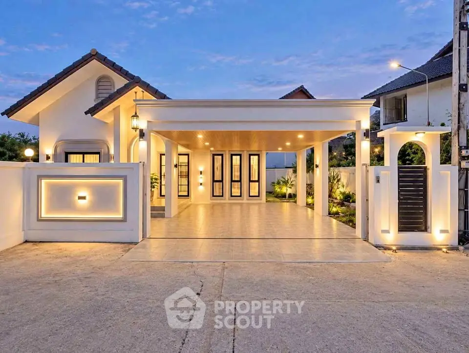 Stunning modern house exterior with elegant lighting and spacious driveway at dusk.