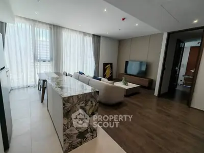 Spacious modern living room with elegant decor and large windows in a luxury apartment.