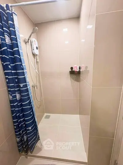Modern bathroom with sleek shower and stylish blue curtain
