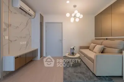 Modern living room with elegant sofa and stylish lighting in a cozy apartment.