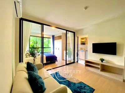 Modern living room with glass partition, cozy sofa, and stylish decor