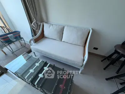 Charming small living room with elegant sofa and unique trunk-style coffee table.