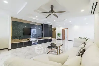 Spacious modern living room with elegant marble flooring and stylish ceiling fan.