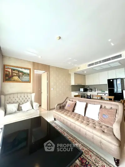 Spacious living room with elegant furniture and modern kitchen in open layout apartment.