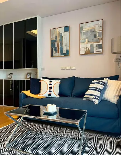 Stylish modern living room with blue sofa and abstract art decor