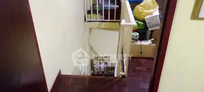 Cozy interior staircase with wooden flooring and storage space, ideal for maximizing home organization.