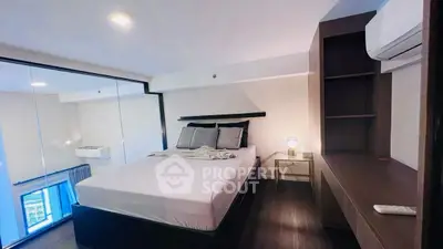 Modern bedroom with sleek design, glass partition, and cozy ambiance