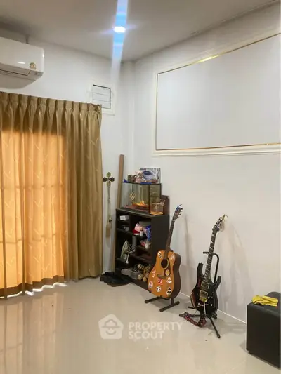 Cozy living room with musical instruments and elegant curtains, perfect for music enthusiasts.