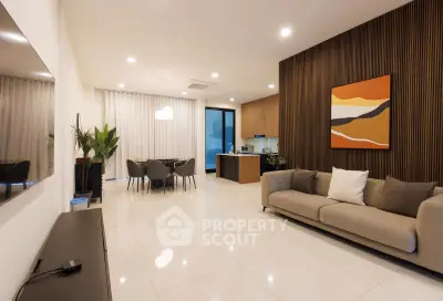 Modern open-plan living room with sleek kitchen and stylish decor