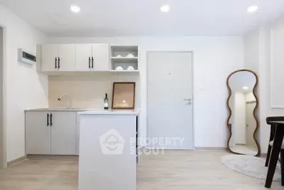 Modern minimalist kitchen with sleek white cabinets and stylish decor