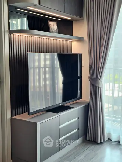 Modern living room with sleek TV unit and elegant curtains, perfect for stylish urban living.