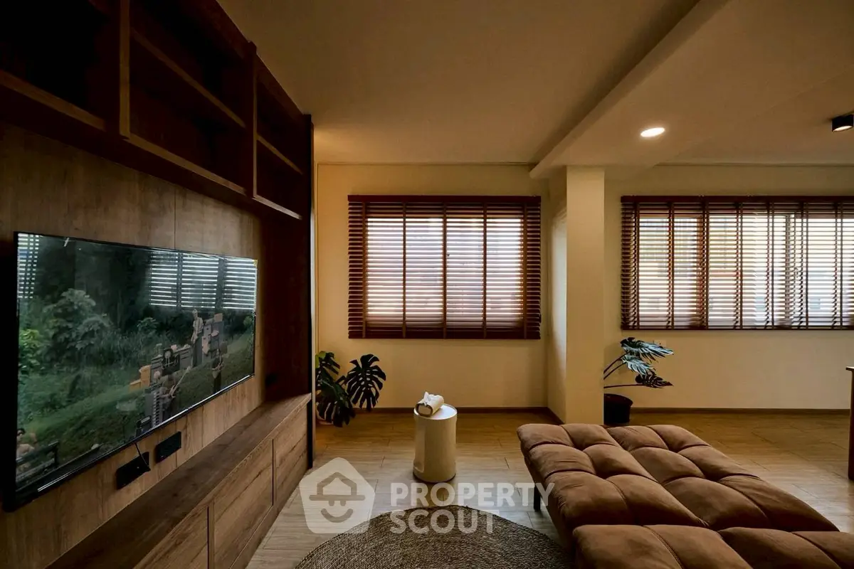 Spacious living room with modern decor and large windows