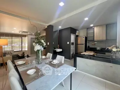 Modern open-plan kitchen and dining area with elegant decor and natural light