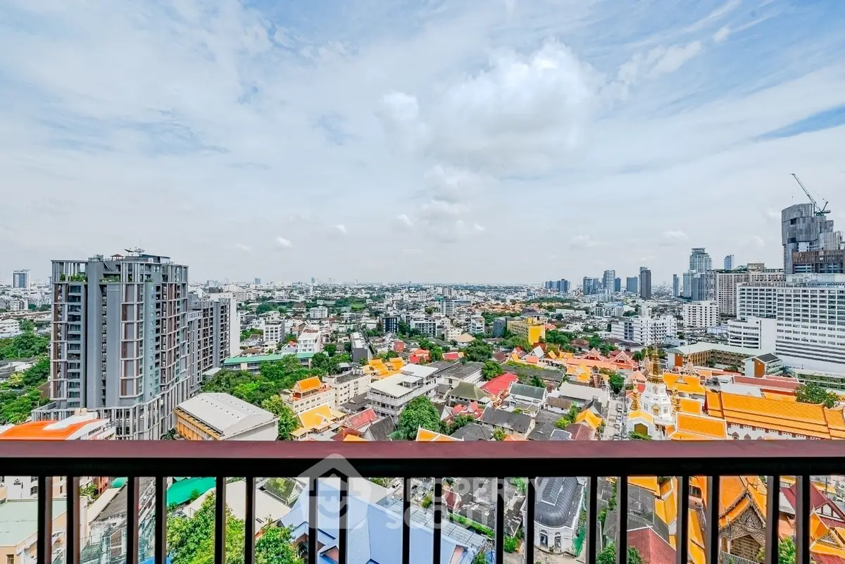 Stunning panoramic city view from high-rise balcony, showcasing vibrant urban landscape.