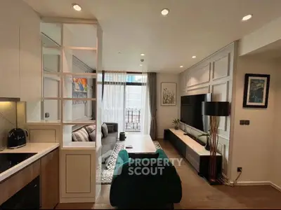 Modern living room with stylish decor and open layout, featuring a cozy seating area and elegant lighting.