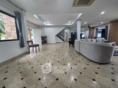 Spacious living room with elegant marble flooring and modern furniture in a luxurious home.