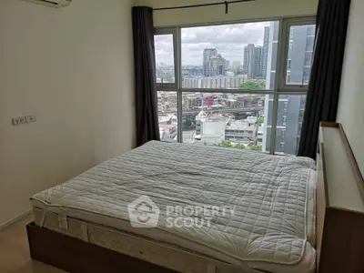Modern bedroom with city view in high-rise apartment