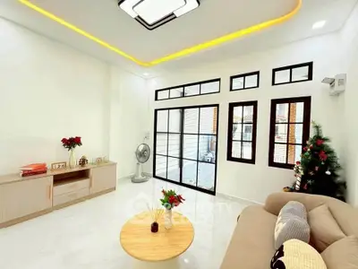 Bright and modern living room with large windows and elegant decor, perfect for relaxation and entertaining.