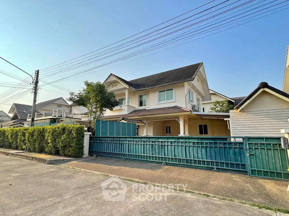 Charming suburban house with spacious driveway and lush greenery, perfect for family living.