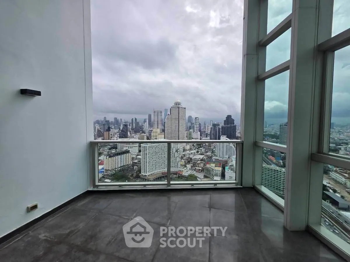 Stunning high-rise balcony with panoramic city skyline view, perfect for urban living enthusiasts.
