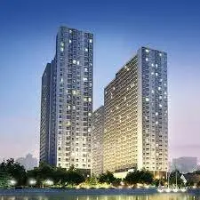 Stunning illuminated high-rise residential buildings with city skyline backdrop.