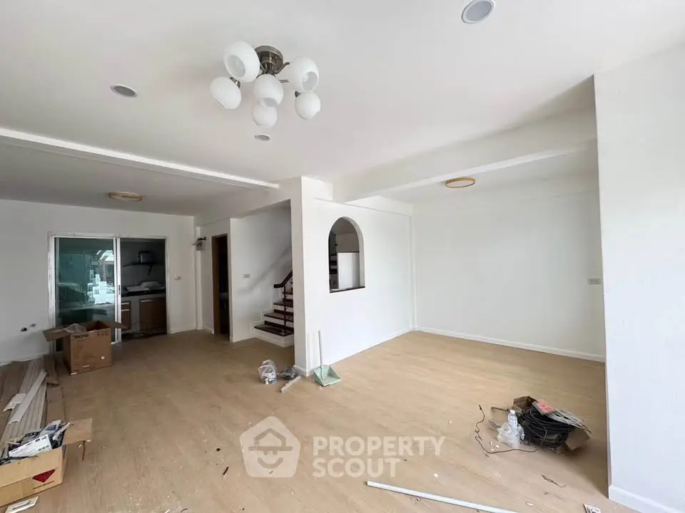 Spacious living room with modern lighting and open layout, ideal for family gatherings.