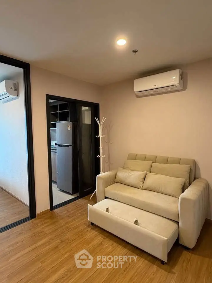 Modern living room with cozy sofa and air conditioning in a stylish apartment.