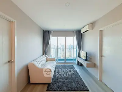 Modern living room with city view, featuring a cozy sofa and sleek decor.