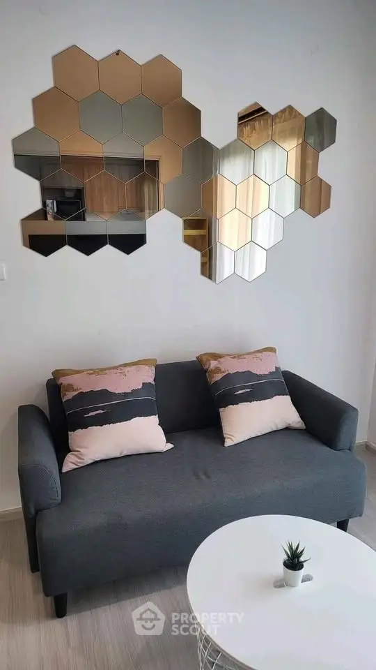 Stylish living room with modern hexagonal mirror decor and cozy sofa