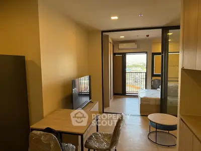 Modern apartment interior with open living area and bedroom view